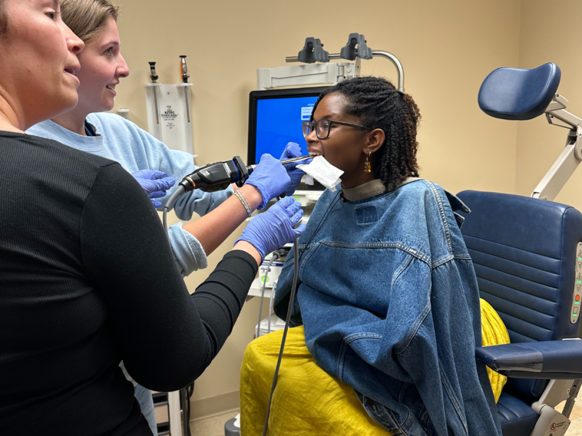 A VUSM student practices taking a scan of another student's mouth.